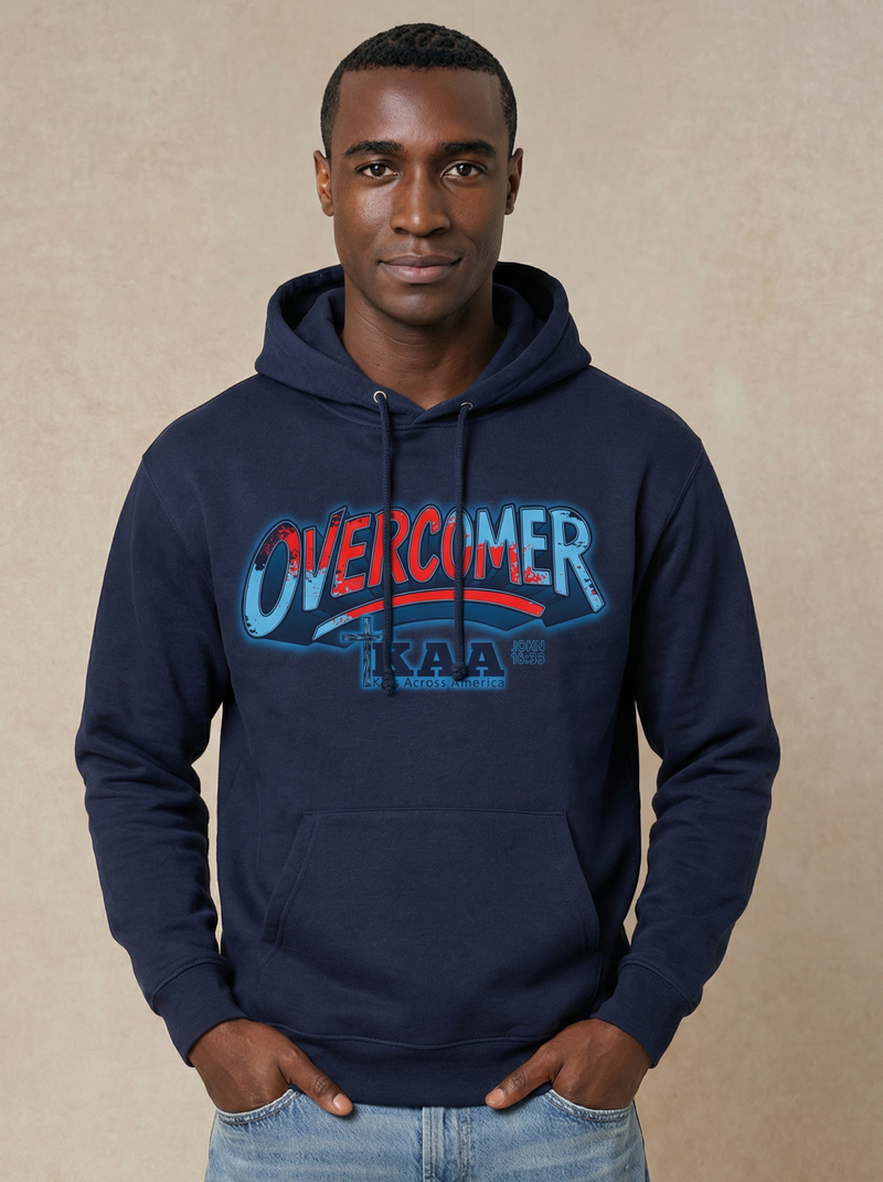 Man wearing a navy hoodie with 'OVERCOMER' text on a beige background