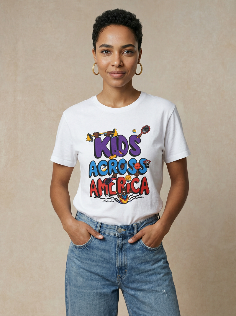 Person wearing a white t-shirt with colorful text 'KIDS ACROSS AMERICA' on a beige background